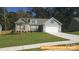 Charming two-story home with stone accents, a manicured lawn, and a two-car garage at 6347 Honor Ave, Midland, NC 28107