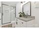 Modern bathroom featuring a glass-enclosed shower, a granite countertop, and stylish fixtures at 703 E Mills Dr, Landis, NC 28088