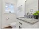 Bathroom featuring granite countertop, framed mirror, and white cabinets at 703 E Mills Dr, Landis, NC 28088