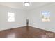 Empty bedroom with hardwood floors and ample natural light from two windows at 703 E Mills Dr, Landis, NC 28088