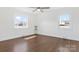 Spacious bedroom featuring hardwood floors, neutral walls, and bright windows at 703 E Mills Dr, Landis, NC 28088