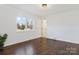 Bright bedroom features a double window for natural light, hardwood floors, and neutral walls at 703 E Mills Dr, Landis, NC 28088