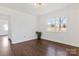 Bright bedroom featuring hardwood floors, neutral walls, and a double window at 703 E Mills Dr, Landis, NC 28088