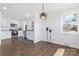 Bright and airy kitchen featuring white cabinets, stainless steel appliances, and hardwood floors at 703 E Mills Dr, Landis, NC 28088