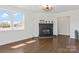 Bright living room with a fireplace, dark hardwood floors, and white trim at 703 E Mills Dr, Landis, NC 28088