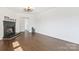 Bright and airy living room featuring dark hardwood floors, fireplace, and white walls at 703 E Mills Dr, Landis, NC 28088