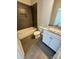 Modern bathroom with tiled walls, a tub, a toilet, and a vanity with granite countertop at 705 Clara St, Gastonia, NC 28054