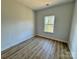 This bedroom features wood-style flooring and a bright window at 705 Clara St, Gastonia, NC 28054