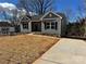 Charming single-story home with gray siding, black shutters, and a well-manicured lawn at 705 Clara St, Gastonia, NC 28054