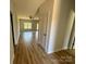 Hallway leading into a spacious living room with wood floors and natural light at 705 Clara St, Gastonia, NC 28054