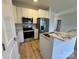 Bright kitchen with white cabinets, stainless steel appliances, and wood flooring at 705 Clara St, Gastonia, NC 28054