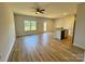 Open-concept living room with wood flooring, a ceiling fan, and access to a backyard deck at 705 Clara St, Gastonia, NC 28054