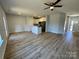 Spacious living room with light walls, wood floors, and a view into the modern kitchen at 705 Clara St, Gastonia, NC 28054