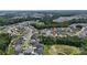 Expansive aerial view of the community and surrounding wooded areas showcase the home's serene location at 7200 Irongate Dr, Lancaster, SC 29720