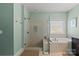Elegant bathroom featuring a glass shower, a separate soaking tub, neutral-colored walls, and modern fixtures at 7200 Irongate Dr, Lancaster, SC 29720