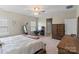 Calm bedroom with neutral walls, ceiling fan, carpet, and complemented by a wooden dresser and mirror at 7200 Irongate Dr, Lancaster, SC 29720