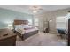 Relaxing bedroom features a wooden bed frame, decorative wall art, and a work area with an ergonomic chair at 7200 Irongate Dr, Lancaster, SC 29720