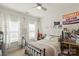 Comfortable bedroom featuring a black metal bed frame, a desk, and bright windows for natural light at 7200 Irongate Dr, Lancaster, SC 29720