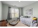 Cozy bedroom featuring a daybed, neutral-toned walls, a large window with blinds, and decorative wall art at 7200 Irongate Dr, Lancaster, SC 29720