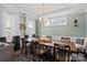 Elegant dining room featuring a large wooden table, stylish chairs, and ample natural light at 7200 Irongate Dr, Lancaster, SC 29720