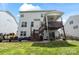 Back of home offers a deck, patio, grassy lawn, fence and an outdoor living space at 7200 Irongate Dr, Lancaster, SC 29720