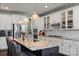 Modern kitchen with granite counters, stainless steel appliances, and a large island with bar stool seating and decorative lighting at 7200 Irongate Dr, Lancaster, SC 29720