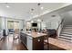 Open-concept living area flowing from the kitchen to dining and Gathering room with hardwood floors throughout the house at 7200 Irongate Dr, Lancaster, SC 29720