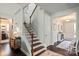 Charming staircase featuring wood steps, a white banister, and light walls, connecting different levels of the home at 7200 Irongate Dr, Lancaster, SC 29720