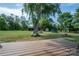 This outdoor area features a wooden deck overlooking a large backyard with lush green space and mature trees at 7271 Hallman Mill Rd, Vale, NC 28168