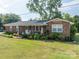 This charming brick home boasts a well-manicured lawn and mature landscaping, enhancing its curb appeal at 7271 Hallman Mill Rd, Vale, NC 28168