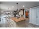 Open concept kitchen with a large wooden island, white cabinets, and a dining area perfect for gatherings at 7271 Hallman Mill Rd, Vale, NC 28168