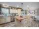 Bright kitchen featuring a wooden island, stainless steel appliances, and a view of the adjacent dining area at 7271 Hallman Mill Rd, Vale, NC 28168