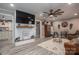 Spacious living room featuring wood-look floors, a large TV, and stylish décor with a cozy seating area at 7271 Hallman Mill Rd, Vale, NC 28168