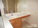 Bathroom featuring single sink vanity, large mirror, and tiled floors at 8319 Golf Ridge Dr, Charlotte, NC 28277