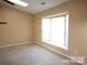 This bedroom has carpet and a bay window for natural light at 8319 Golf Ridge Dr, Charlotte, NC 28277