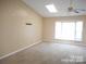 This bedroom has vaulted ceilings, carpet, and a bay window for natural light at 8319 Golf Ridge Dr, Charlotte, NC 28277