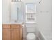 Bathroom with wood vanity, toilet, tub/shower combo, and natural light from a window at 8410 Scotney Bluff Ave, Charlotte, NC 28273