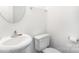 Simple bathroom with white walls, a white sink, and a standard toilet at 8410 Scotney Bluff Ave, Charlotte, NC 28273