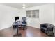 Bedroom with dark wood floors features a modern desk and leather chair at 8410 Scotney Bluff Ave, Charlotte, NC 28273