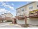 Exterior view showcasing townhomes with attached garages and private wooden balconies at 8410 Scotney Bluff Ave, Charlotte, NC 28273