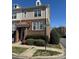 Charming brick-and-siding townhouse with a covered entrance, landscaping, and a street sign at 8410 Scotney Bluff Ave, Charlotte, NC 28273