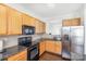 A modern kitchen with stainless steel appliances, granite countertops, and wooden cabinets at 8410 Scotney Bluff Ave, Charlotte, NC 28273