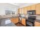 A kitchen showcases stainless steel appliances, granite countertops, tile backsplash, and wood cabinets at 8410 Scotney Bluff Ave, Charlotte, NC 28273