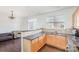 View of kitchen with stainless sink and wooden cabinets, open to living area, and with granite countertops at 8410 Scotney Bluff Ave, Charlotte, NC 28273