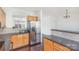 Kitchen area with stainless steel refrigerator, dark wood flooring, and view to adjacent room at 8410 Scotney Bluff Ave, Charlotte, NC 28273