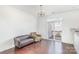 Bright living room featuring hardwood floors, with tan sofa and love seat, access to an outdoor deck through sliding glass doors at 8410 Scotney Bluff Ave, Charlotte, NC 28273