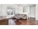 Comfortable living room boasts hardwood floors, neutral walls, and a staircase to the upper level at 8410 Scotney Bluff Ave, Charlotte, NC 28273