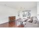 Bright living room features hardwood floors, a ceiling fan, and ample natural light from large windows at 8410 Scotney Bluff Ave, Charlotte, NC 28273