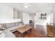 Bright living room featuring hardwood floors, a comfortable gray sectional, and an inviting atmosphere at 8410 Scotney Bluff Ave, Charlotte, NC 28273