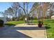 Landscaped backyard with a patio, offering a tranquil outdoor retreat at 916 Somersby Ln, Matthews, NC 28105